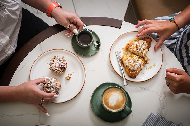friends enjoy pastries and coffee